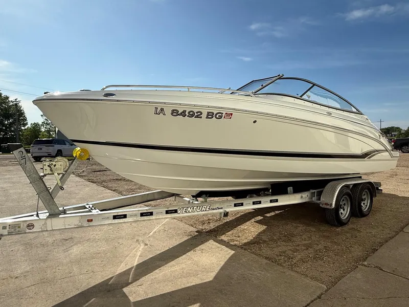 Slide: The Image of 2009 Formula 240 Bowrider boat on trailer under clear blue sky. - 2