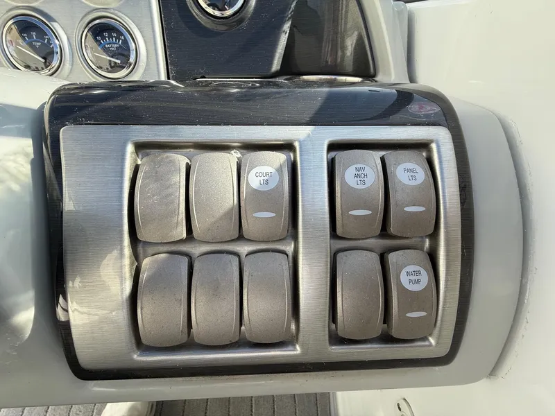 Slide: The Image of Dashboard switches on a 2009 Formula 240 Bowrider boat, including lights and water pump controls. - 20