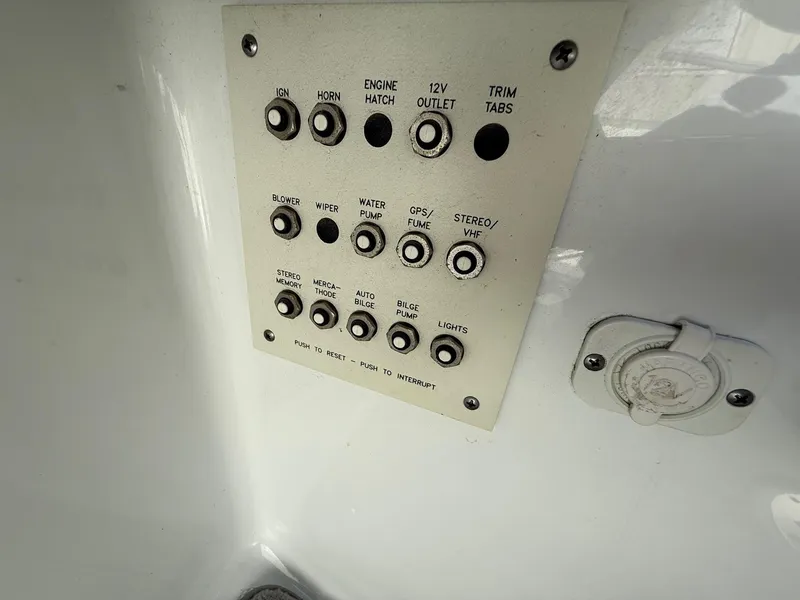 Slide: The Image of Control panel of a 2009 Formula 240 Bowrider boat with various switches and buttons. - 22