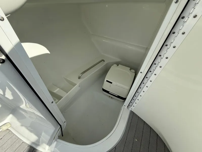 Slide: The Image of 2009 Formula 240 Bowrider boat interior with compact toilet and white finish. - 25