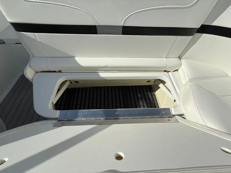 Slide: The Image of 2009 Formula 240 Bowrider boat seat with open storage compartment. - 29