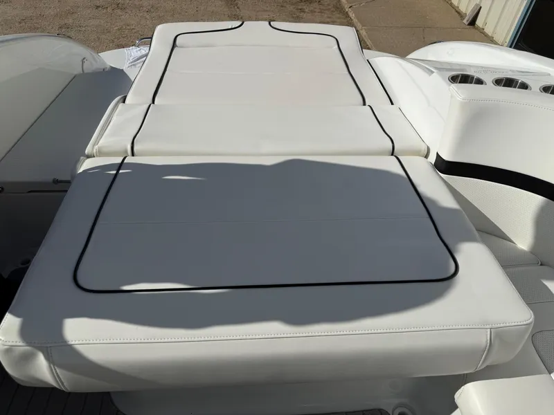 Slide: The Image of 2009 Formula 240 Bowrider boat with white cushioned seating and cup holders. - 32