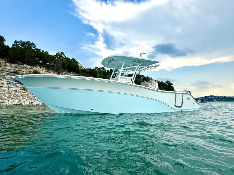 Slide: The Image of 2017 Sea Fox 288 Commander boat on calm water, under a partly cloudy sky. - 1