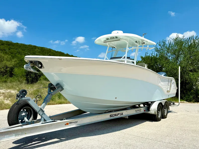 Slide: The Image of 2017 Sea Fox 288 Commander boat on trailer, parked outdoors under blue sky. - 10