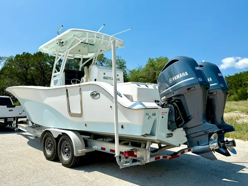 Slide: The Image of 2017 Sea Fox 288 Commander boat on trailer with twin Yamaha engines, parked outdoors. - 12