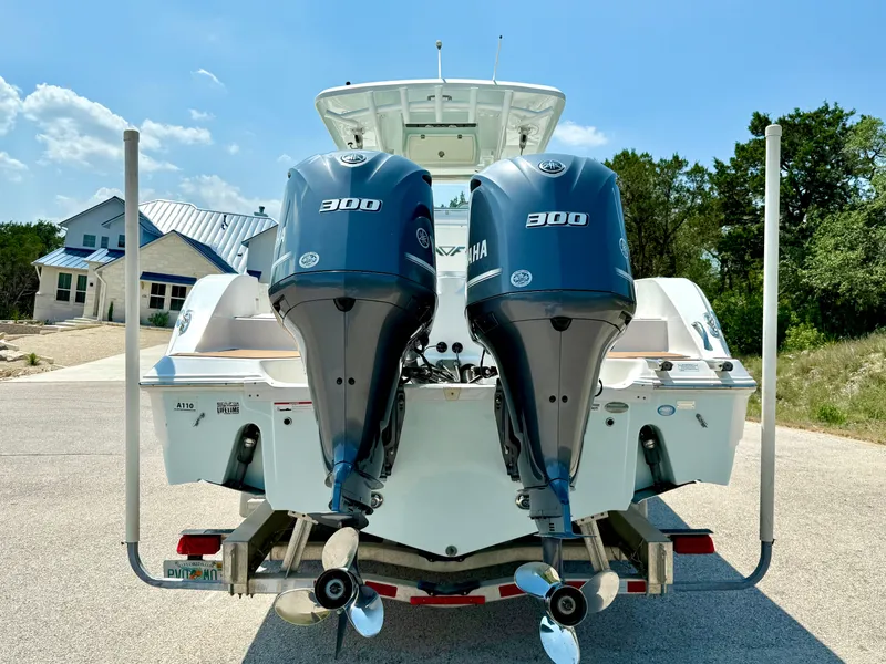 Slide: The Image of 2017 Sea Fox 288 Commander boat with twin Yamaha 300 engines, parked outdoors. - 13