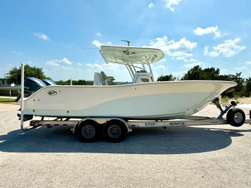Slide: The Image of 2017 Sea Fox 288 Commander boat on trailer under clear blue sky. - 15