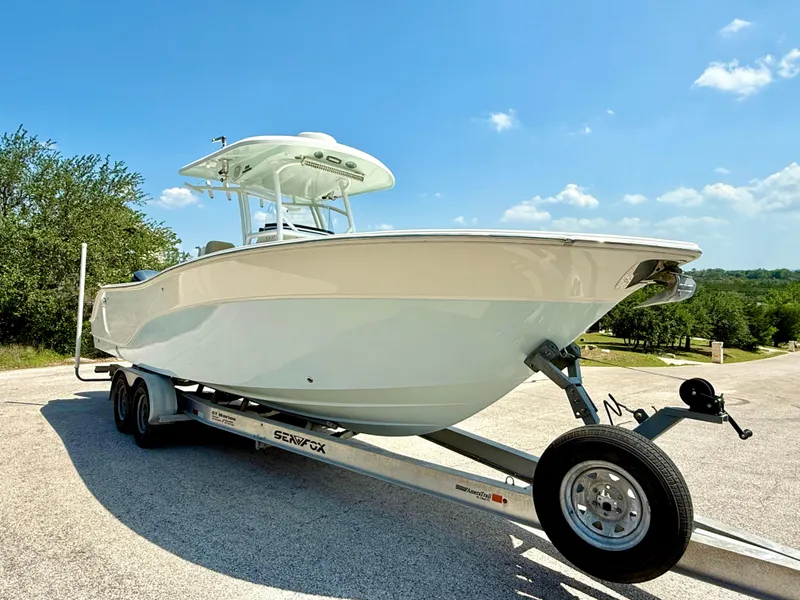 Slide: The Image of 2017 Sea Fox 288 Commander boat on trailer under clear blue sky. - 16
