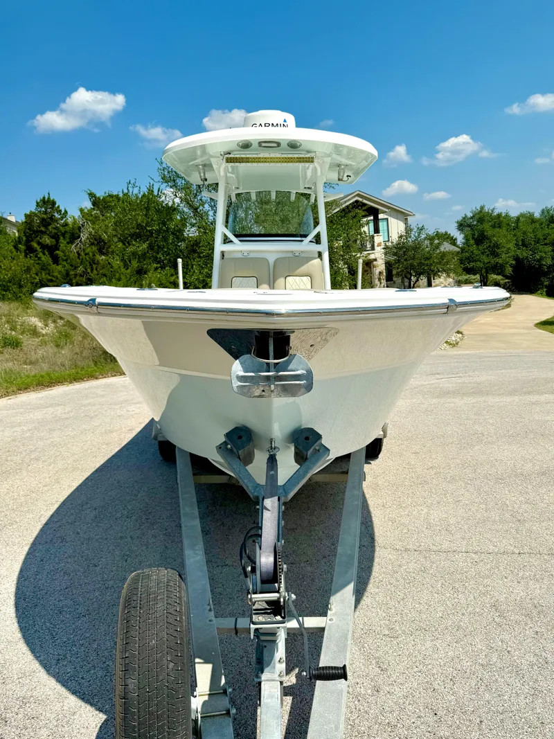 Slide: The Image of 2017 Sea Fox 288 Commander boat on trailer, parked outdoors under a clear blue sky. - 17