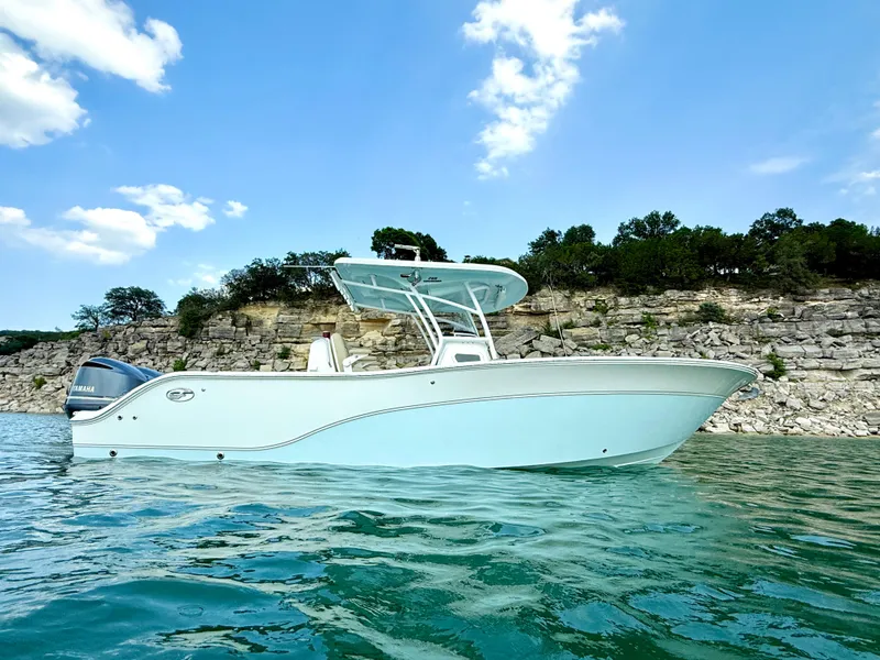 Slide: The Image of 2017 Sea Fox 288 Commander boat on clear water with rocky shoreline background. - 3