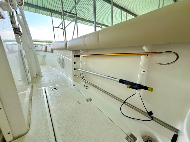 Slide: The Image of 2017 Sea Fox 288 Commander boat interior with fishing rod holders and cushioned seating. - 33