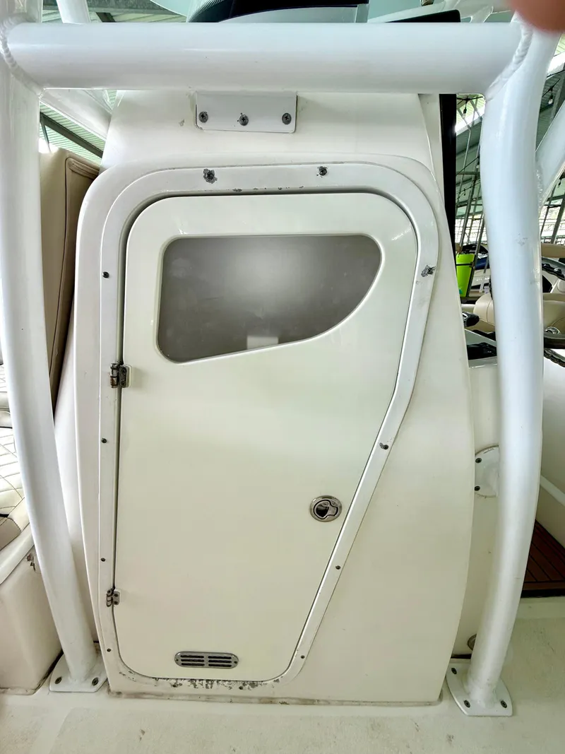 Slide: The Image of 2017 Sea Fox 288 Commander boat cabin door with window, white exterior. - 38