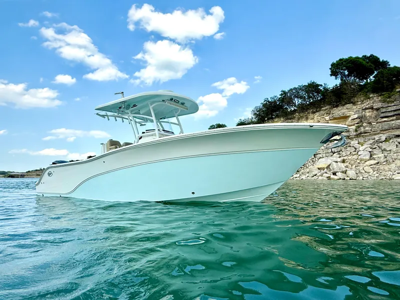 Slide: The Image of Sea Fox 288 Commander 2017 boat on clear water with rocky shoreline and blue sky. - 4