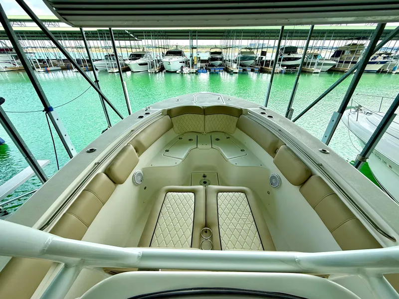 Slide: The Image of 2017 Sea Fox 288 Commander boat interior with beige seating, docked in marina. - 46