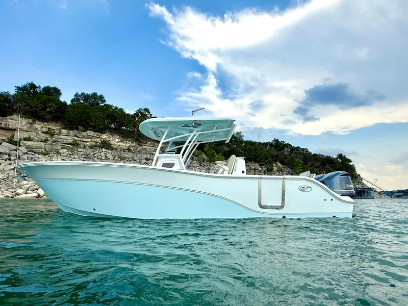 Slide: The Image of 2017 Sea Fox 288 Commander boat on clear water with rocky shoreline background. - 6