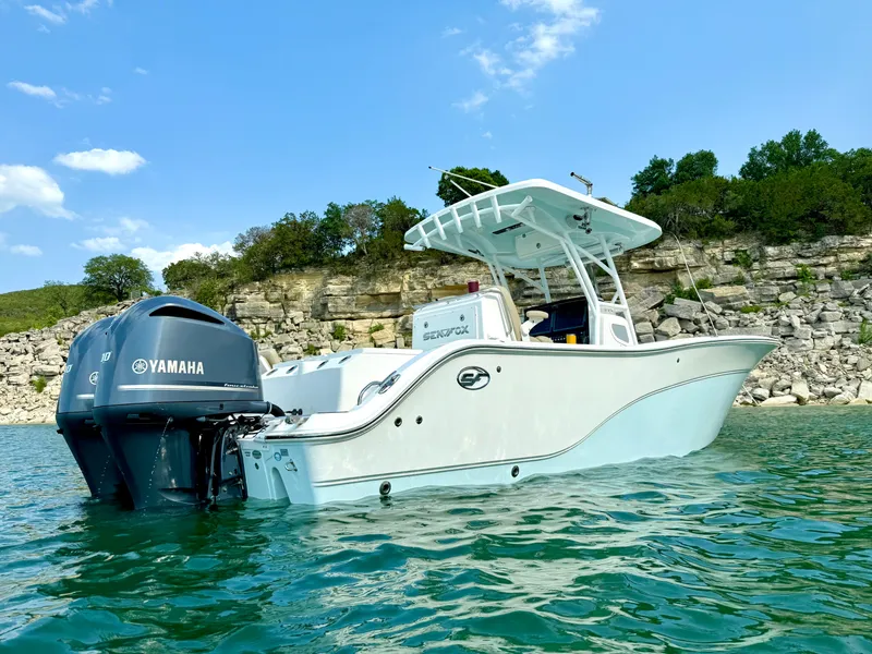 Slide: The Image of 2017 Sea Fox 288 Commander boat on water, Yamaha engine, rocky shoreline background. - 9