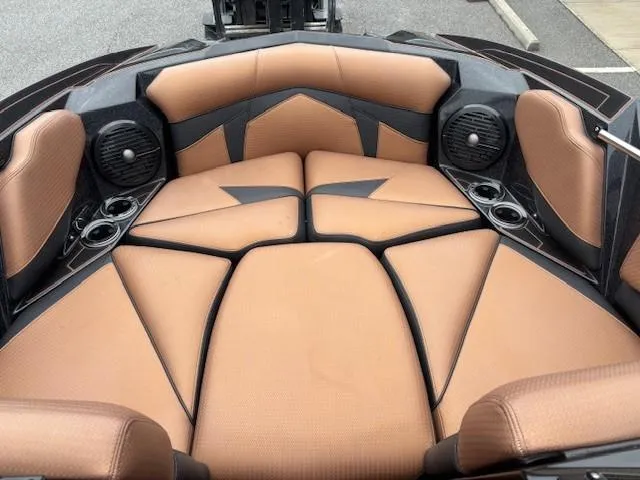 Slide: The Image of 2019 Centurion Fi 25 boat interior with tan seating and built-in speakers. - 10