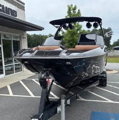 Slide: The Image of 2019 Centurion Fi 25 boat on trailer outside a building. - 2