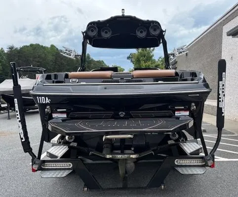 Slide: The Image of 2019 Centurion Fi 25 boat, rear view, parked outdoors, showcasing sleek design and advanced features. - 4