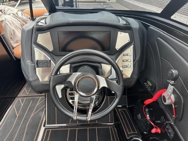Slide: The Image of 2019 Centurion Fi 25 boat dashboard with modern steering wheel and control panel. - 5