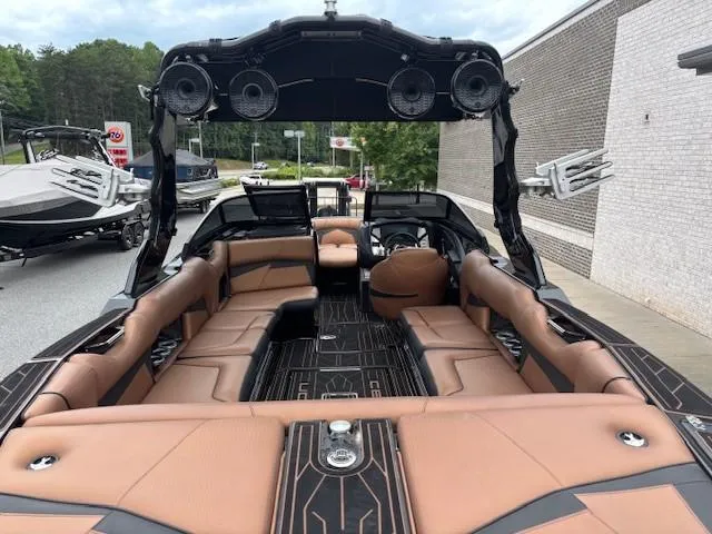 Slide: The Image of 2019 Centurion Fi 25 boat interior with brown seating and black accents. - 9