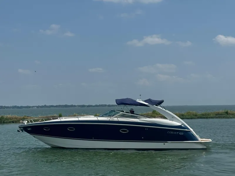 Slide: The Image of 2005 Cobalt 360 boat cruising on a sunny day with clear skies. - 0