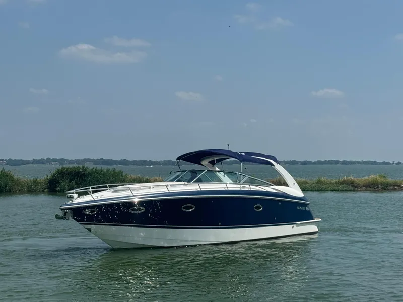 Slide: The Image of 2005 Cobalt 360 boat on calm water under clear blue sky. - 1