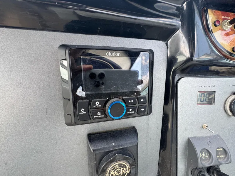 Slide: The Image of Clarion audio system on 2005 Cobalt 360 boat dashboard with control buttons. - 14