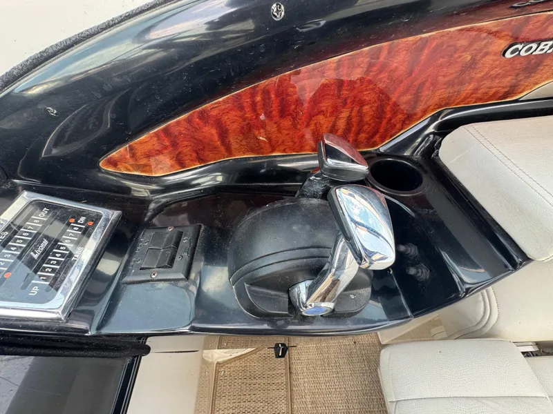 Slide: The Image of Control panel of a 2005 Cobalt 360 boat with wood accents and chrome throttle. - 16