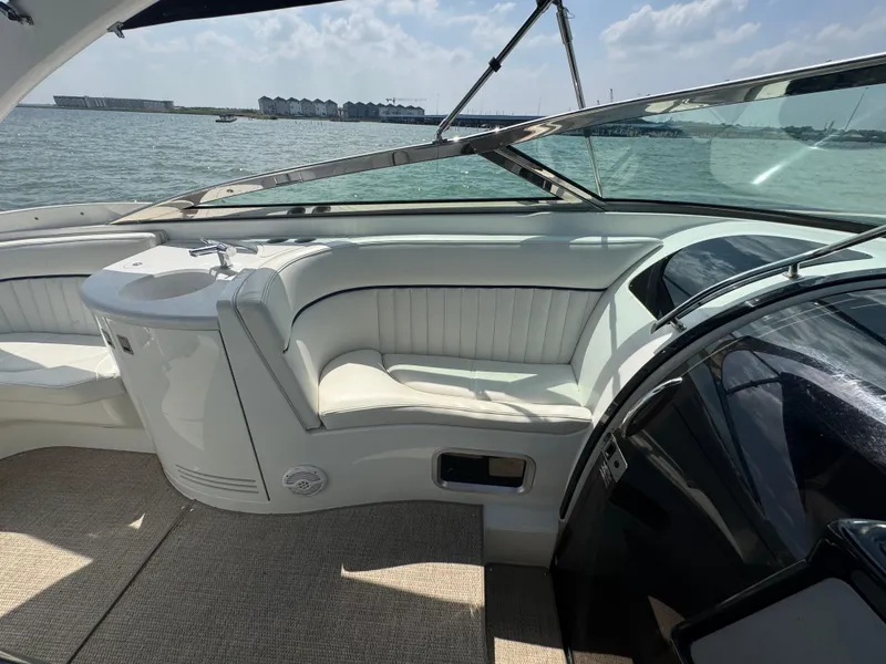 Slide: The Image of 2005 Cobalt 360 boat interior with white seating, overlooking a scenic waterfront. - 18