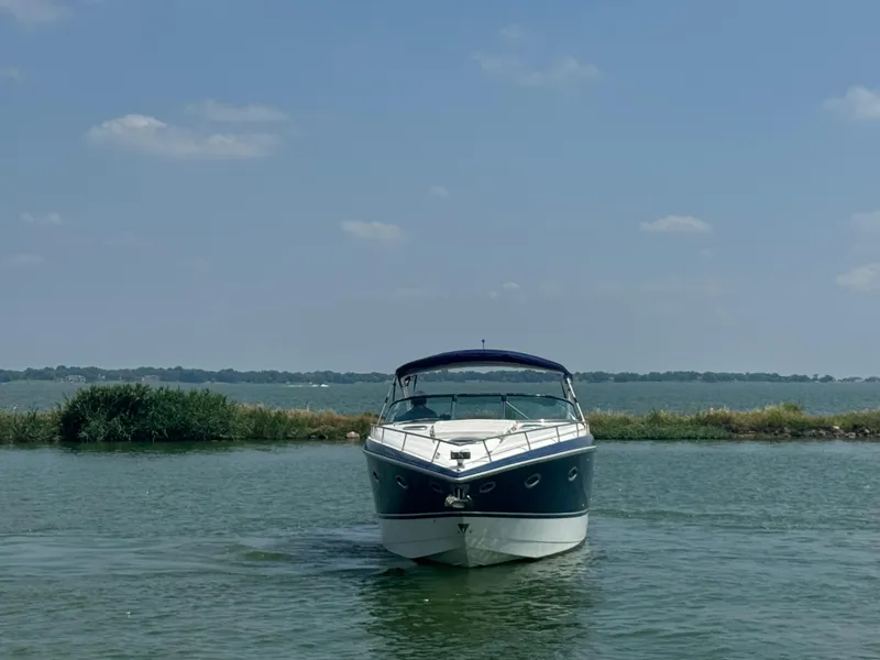 Slide: The Image of 2005 Cobalt 360 boat on calm water under a clear blue sky. - 2