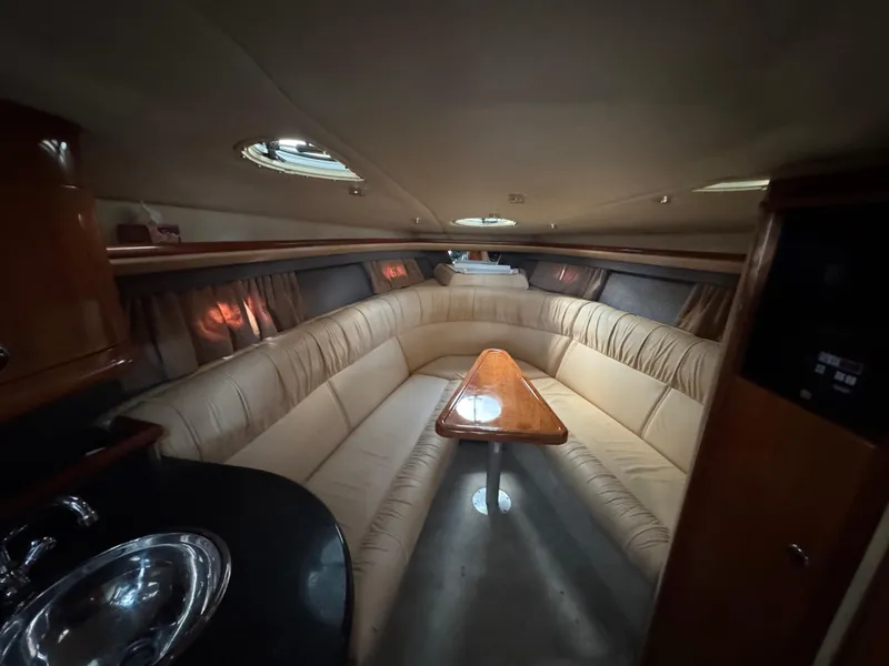 Slide: The Image of Luxurious interior of a 2005 Cobalt 360 yacht with plush seating and wooden table. - 27