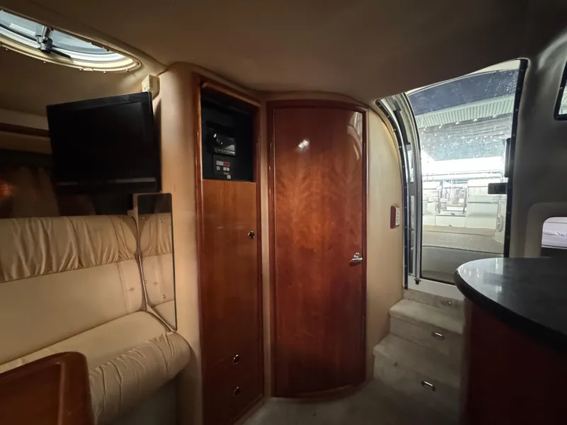 Slide: The Image of Interior of 2005 Cobalt 360 boat with seating, TV, and wooden cabinetry. - 29