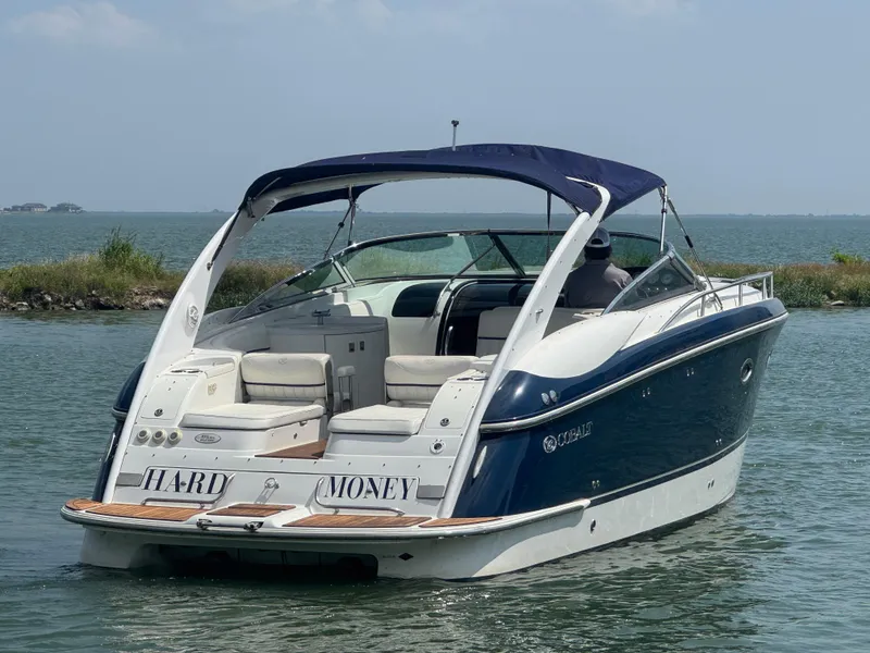 Slide: The Image of 2005 Cobalt 360 boat on water, blue and white design, rear view. - 5