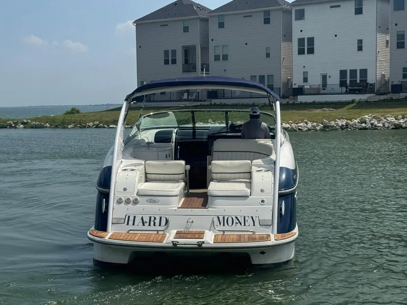 Slide: The Image of Cobalt 360 boat from 2005 named "Hard Money" on water near waterfront homes. - 6