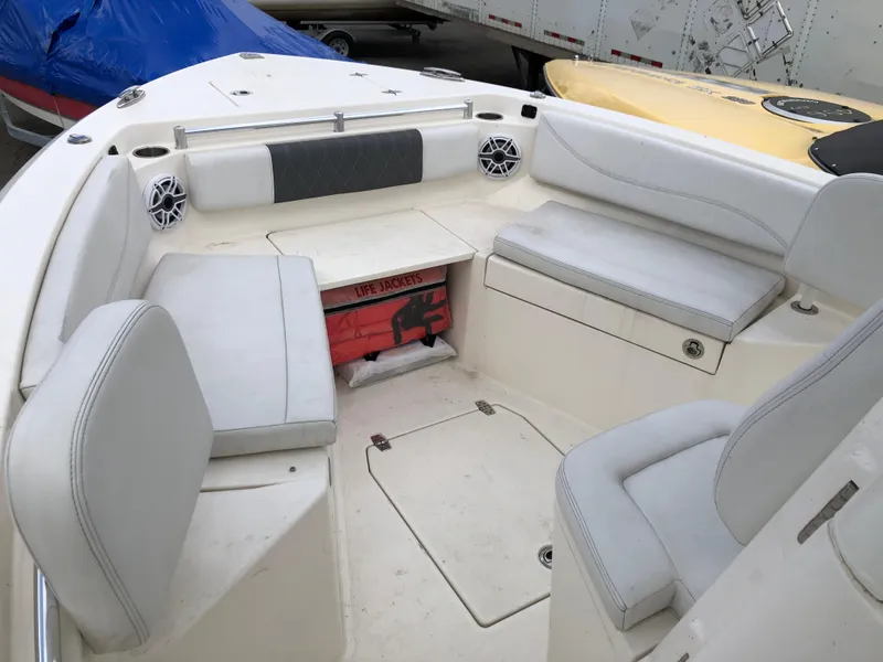 Slide: The Image of 2021 Cobia 240 CC boat interior with cushioned seating and storage compartments. - 4