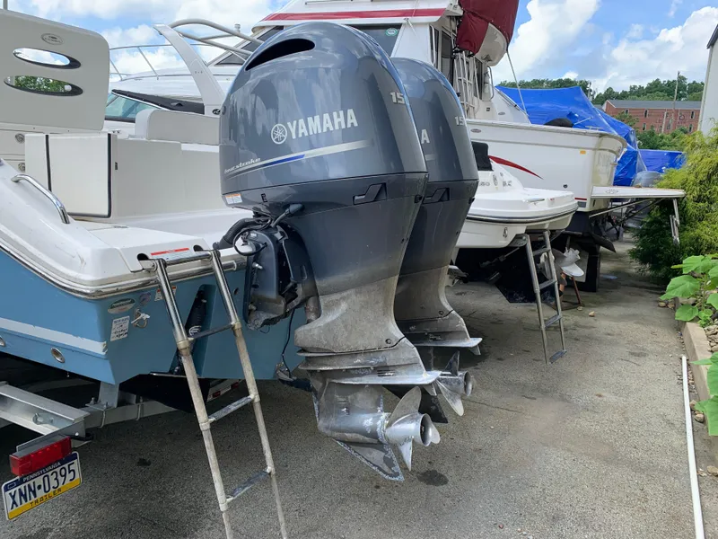 Slide: The Image of 2021 Cobia 240 CC boat with twin Yamaha outboard motors, parked on a trailer. - 9