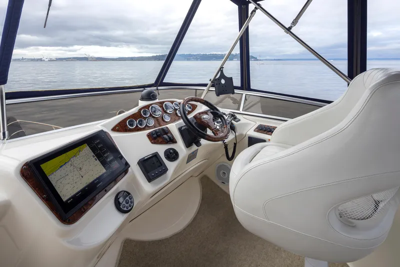 Slide: The Image of 2008 Meridian 391 Sedan helm with navigation screens and steering wheel, overlooking calm waters. - 12