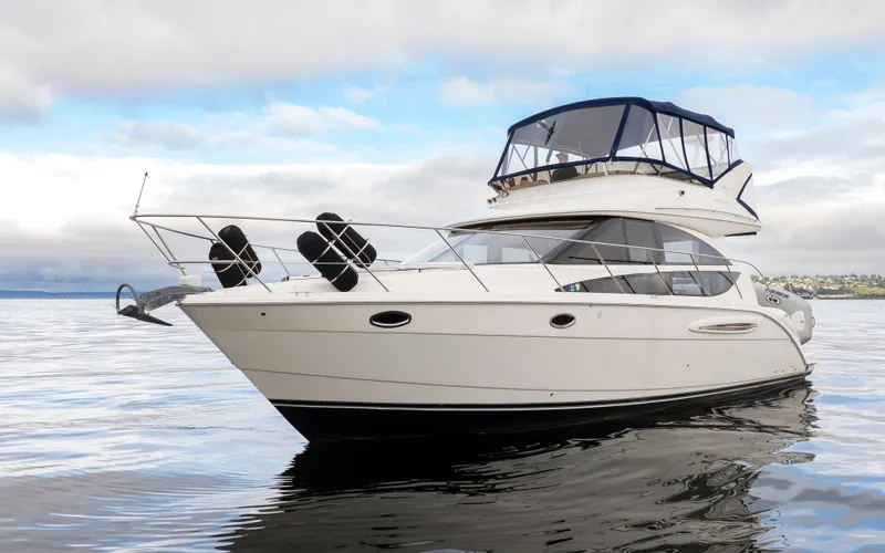 Slide: The Image of 2008 Meridian 391 Sedan yacht on calm water under cloudy sky. - 2