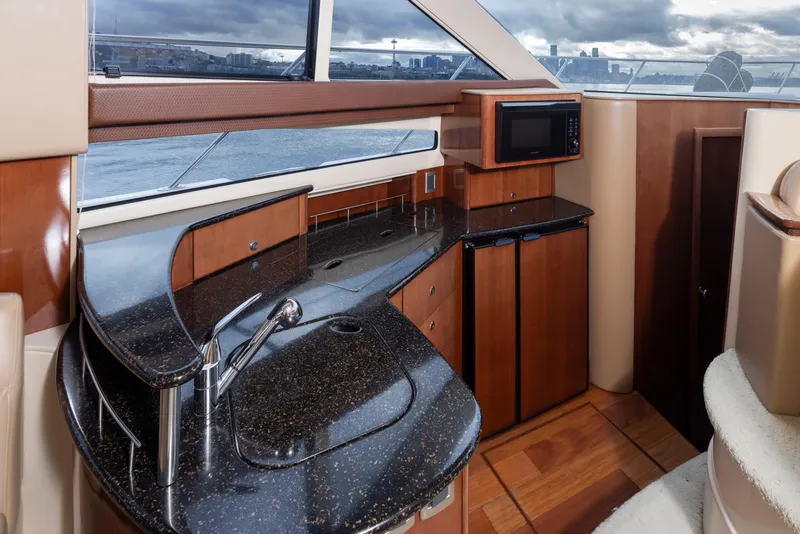 Slide: The Image of Luxurious interior of 2008 Meridian 391 Sedan yacht with modern kitchen amenities. - 22