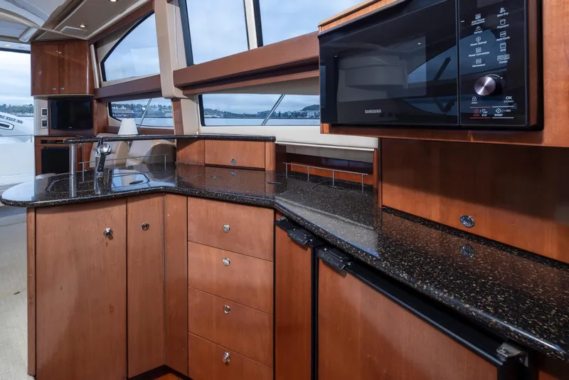 Slide: The Image of 2008 Meridian 391 Sedan yacht kitchen with wood cabinetry and modern appliances. - 23