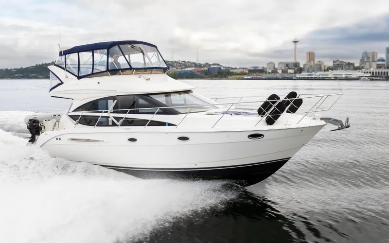 Slide: The Image of 2008 Meridian 391 Sedan cruising on water with city skyline in background. - 3