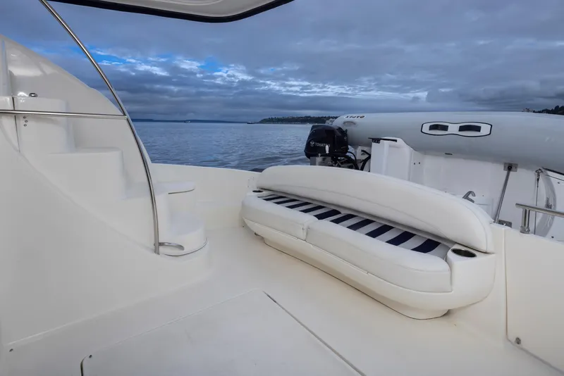 Slide: The Image of 2008 Meridian 391 Sedan yacht deck with seating, overlooking calm waters and cloudy sky. - 36