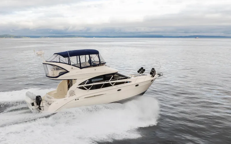 Slide: The Image of 2008 Meridian 391 Sedan cruising on open water under cloudy skies. - 44