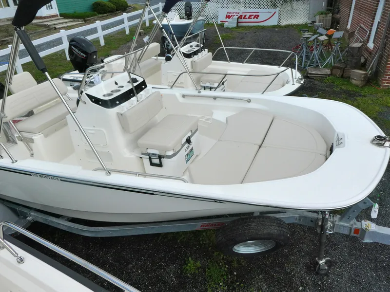 Slide: The Image of 2025 Boston Whaler 170 Montauk boat on trailer, featuring spacious seating and modern design. - 3