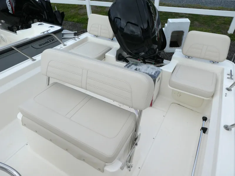 Slide: The Image of 2025 Boston Whaler 170 Montauk boat interior with seating and engine view. - 7