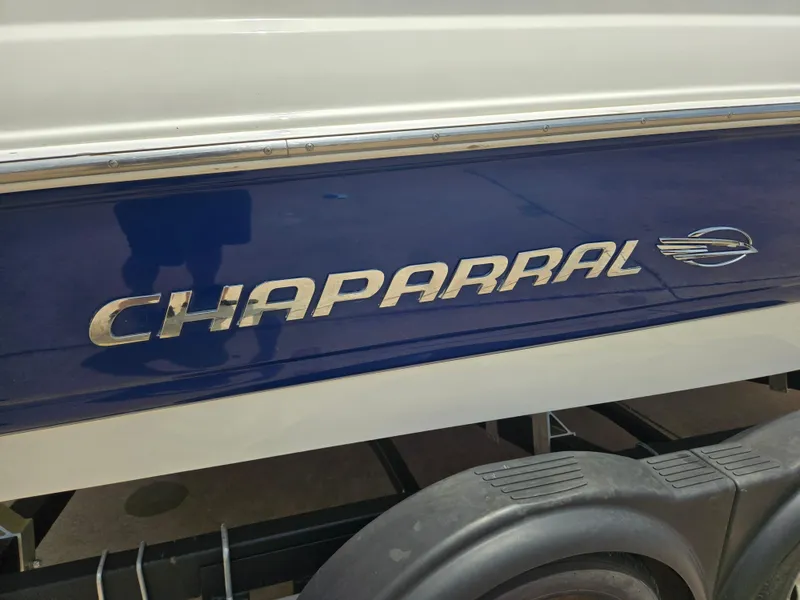 Slide: The Image of 2007 Chaparral 210 SSi boat side view with logo and trailer. - 14