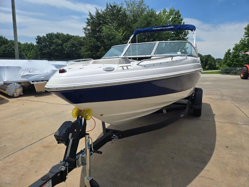Slide: The Image of 2007 Chaparral 210 SSi boat on trailer, parked outdoors under a clear sky. - 3