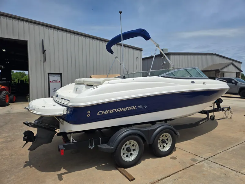 Slide: The Image of 2007 Chaparral 210 SSi boat on trailer, parked outside a warehouse. - 4