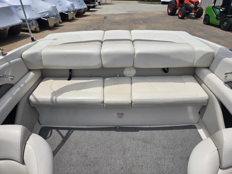 Slide: The Image of 2007 Chaparral 210 SSi boat interior with white cushioned seating and carpeted floor. - 8